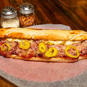 Italian Grinder,Pepperoni, Ham, Banana Pepper Rings, Onions, Italian Dressing, Topped with Parmesan & Romano